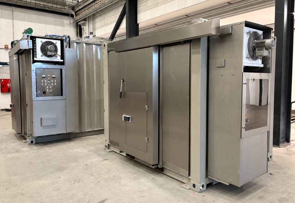 Two stainless steel offshore containers – a refrigeration and a freezer container – in a workshop